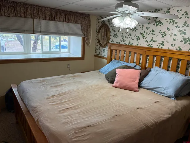 a bedroom with a bed and a window