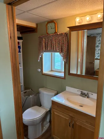 a bathroom with a toilet sink and mirror