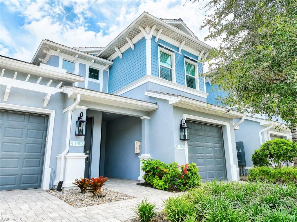 2620 Seychelles Circle, Unit 1302 Naples, FL 34112 - Photo 2 of 43 a front view of a house with a yard