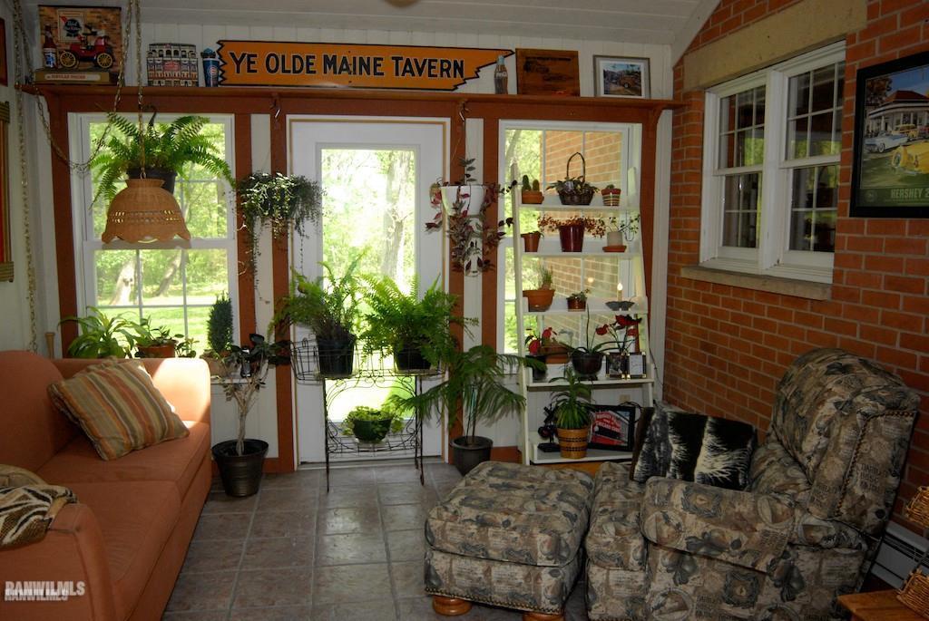 18939 Timberlake Road Mount Carroll, IL 61053 - Photo 8 of 25 a living room filled with furniture window and garden view