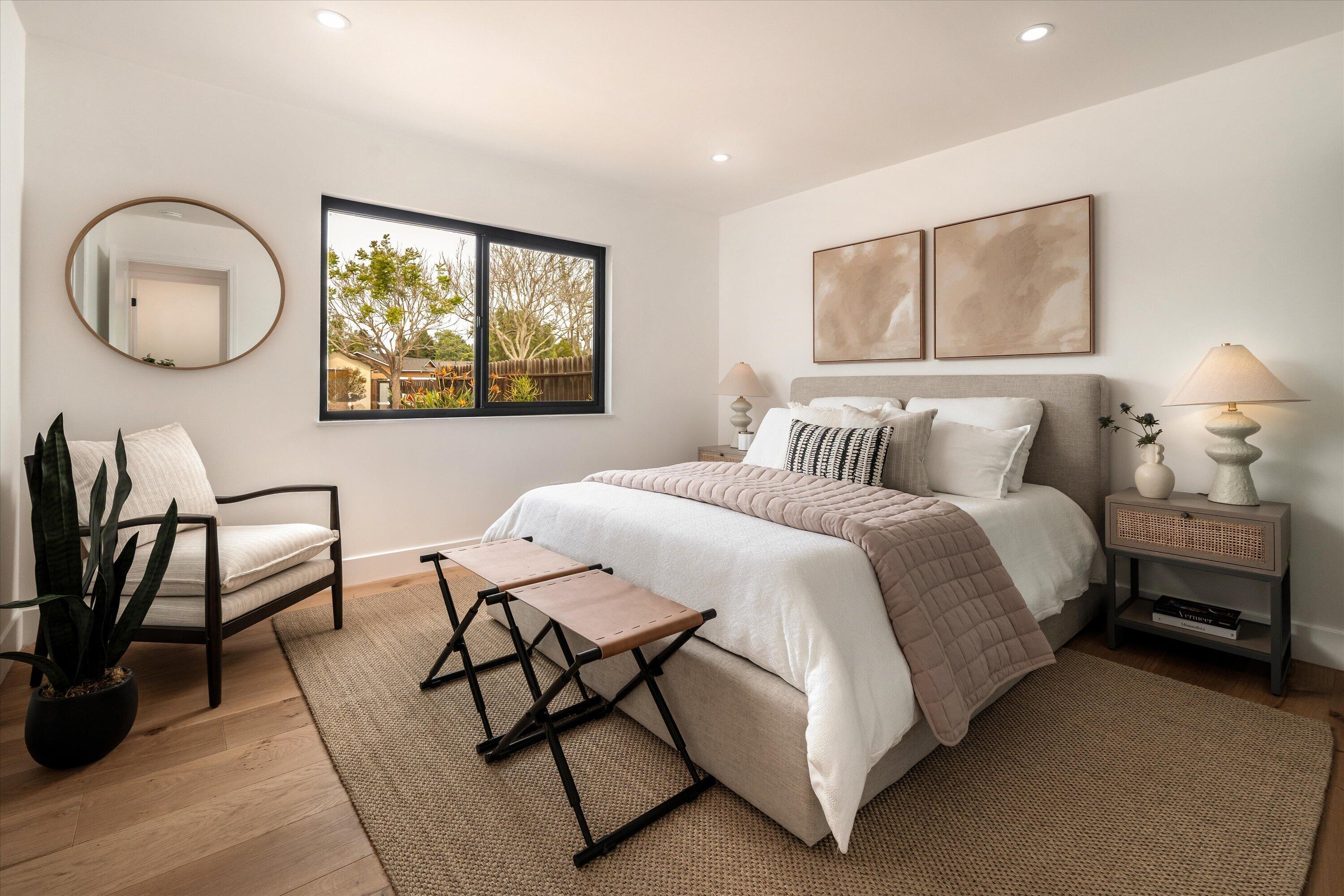 674 Burtis Street Santa Barbara, CA 93111 - Photo 11 of 29 a bedroom with a bed a mirror on desk and a window