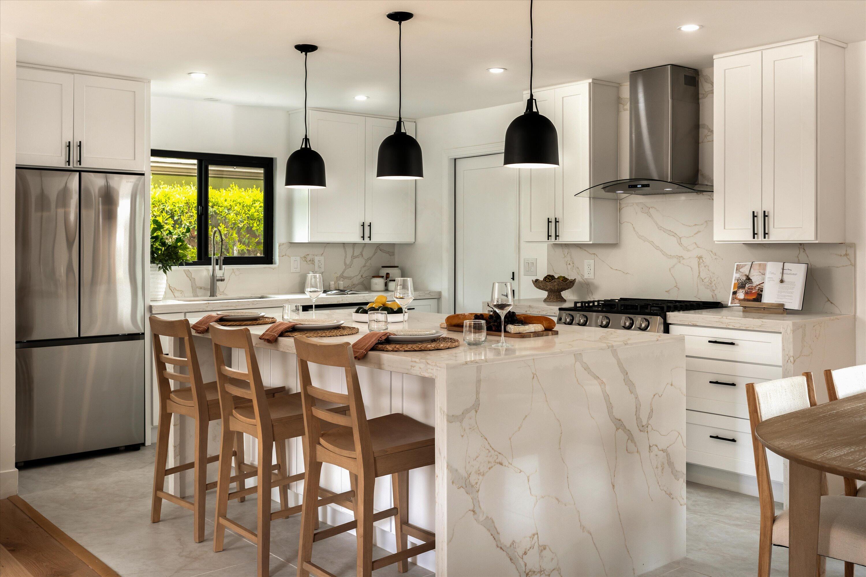 674 Burtis Street Santa Barbara, CA 93111 - Photo 7 of 29 a kitchen with stainless steel appliances granite countertop a stove a refrigerator a oven a sink a dining table and chairs with wooden floor