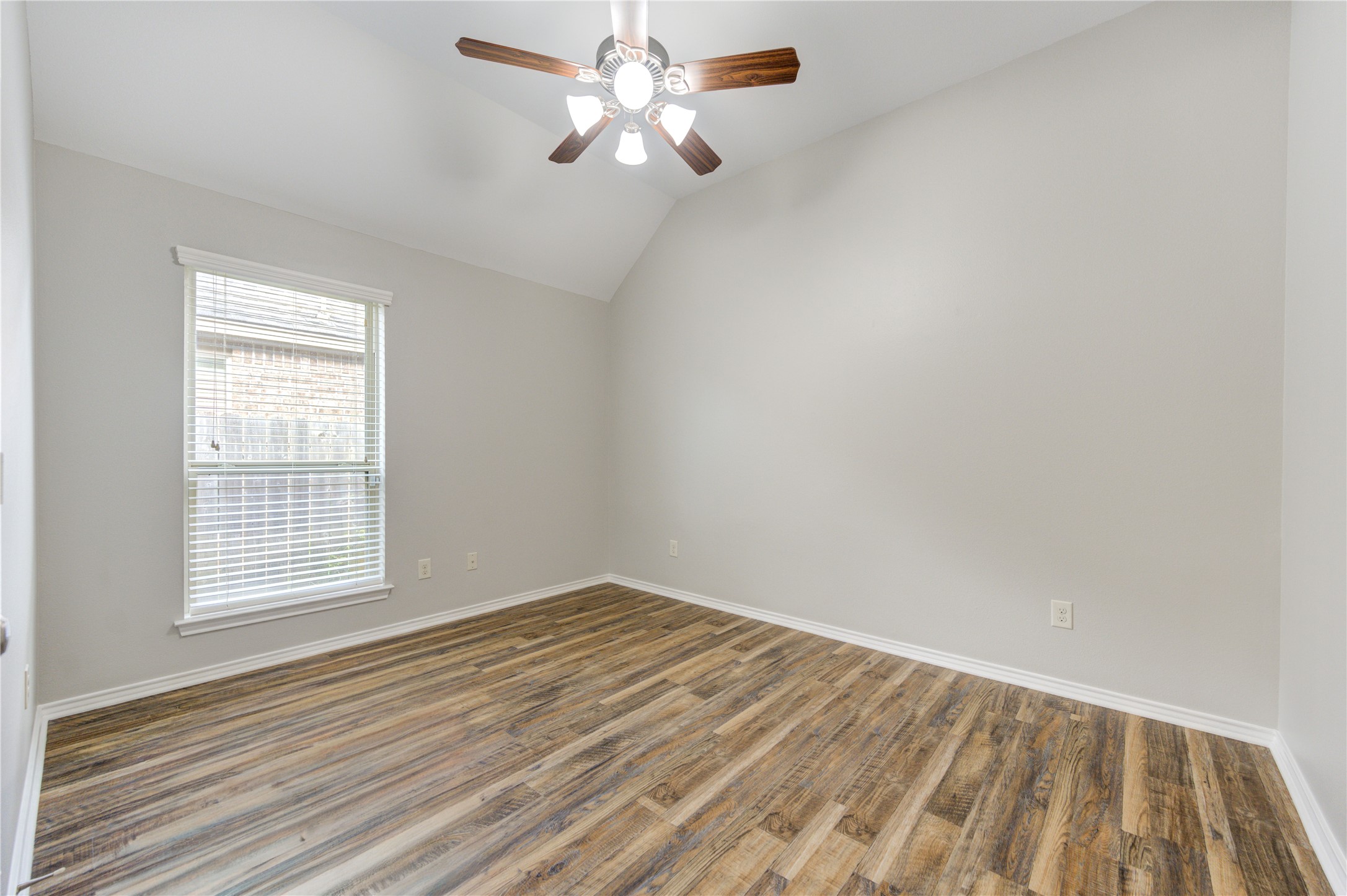 27407 Gatlin Lane Spring, TX 77386 - Photo 28 of 35 Bright and versatile, this generously sized secondary bedroom features neutral finishes, elevated ceilings, and easy-care flooring.