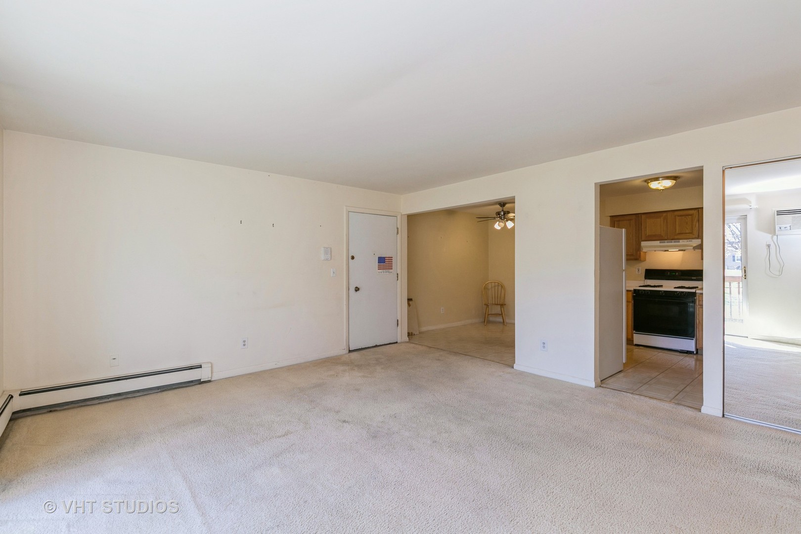 19330 Wolf Road, Unit 4 Mokena, IL 60448 - Photo 6 of 11 an empty room with closet and a kitchen view