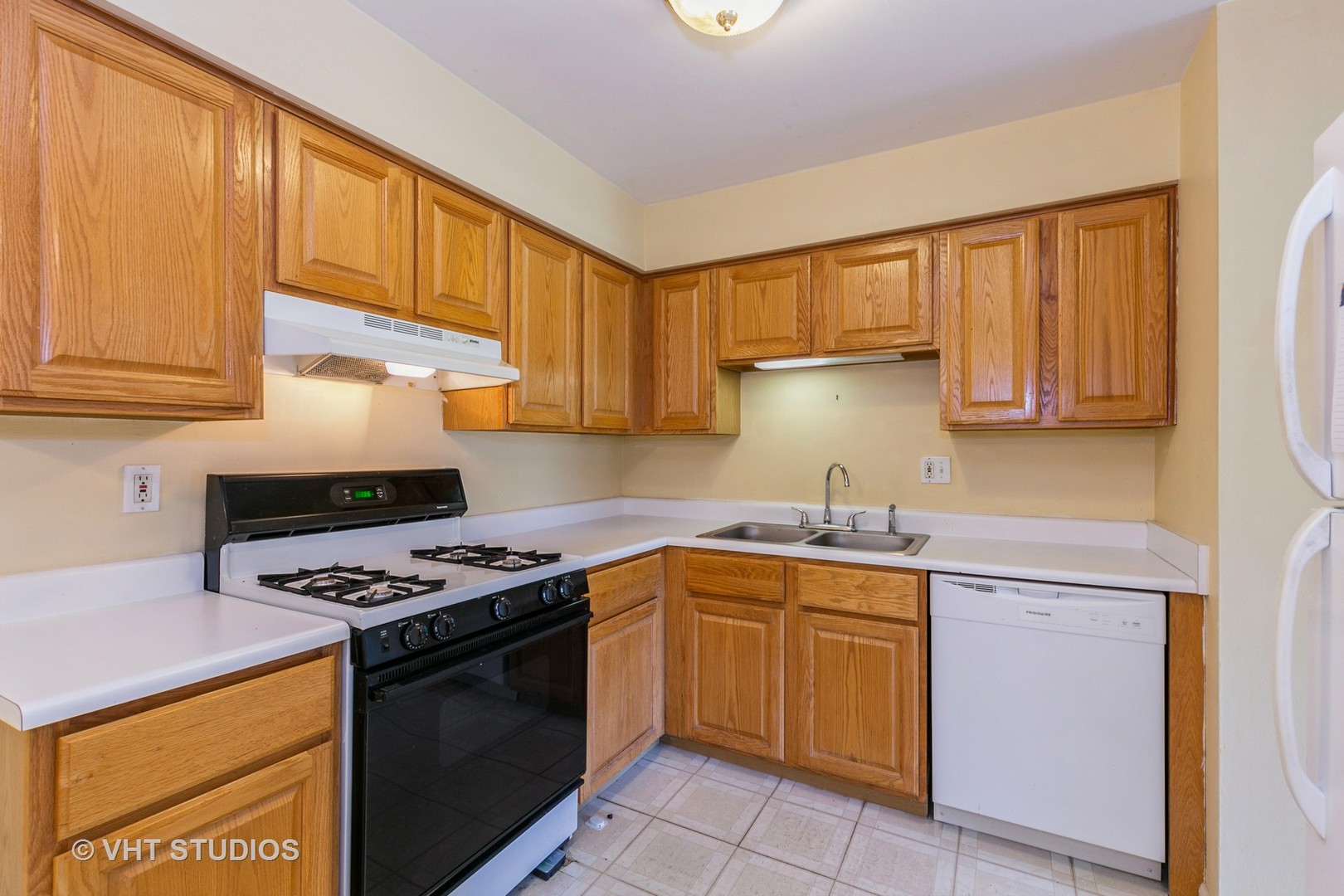 19330 Wolf Road, Unit 4 Mokena, IL 60448 - Photo 9 of 11 a kitchen with a sink stove top oven and cabinets