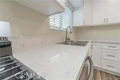 a kitchen with a sink and a stove top oven