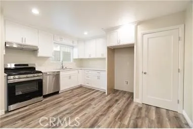 a kitchen with a stove oven and sink