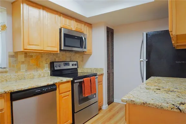 a kitchen with a sink and a refrigerator