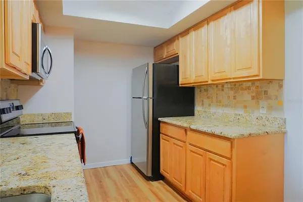 a kitchen with a sink stove top oven and microwave
