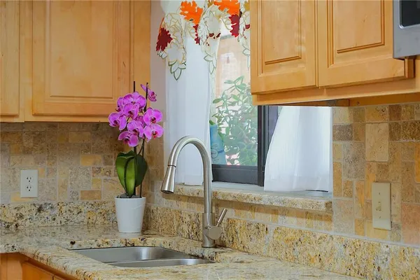 a bedroom with a bed and a potted plant