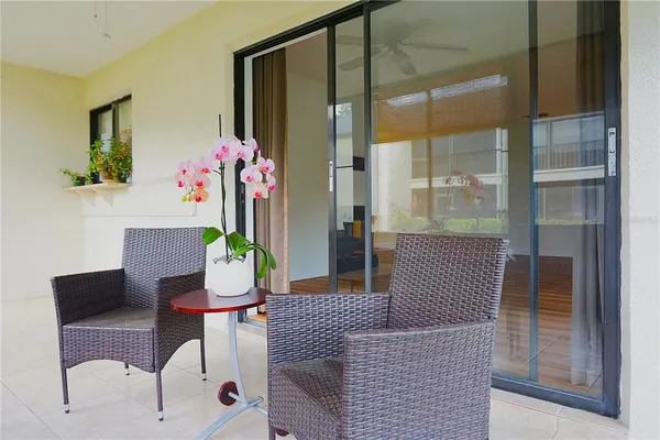 a dining room with furniture a chandelier and glass door