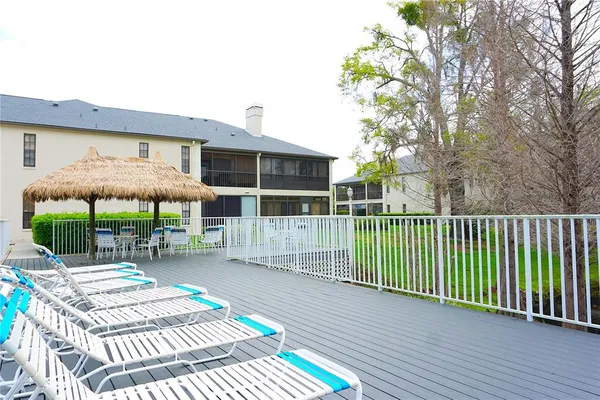 a view of a lake with a yard and large trees