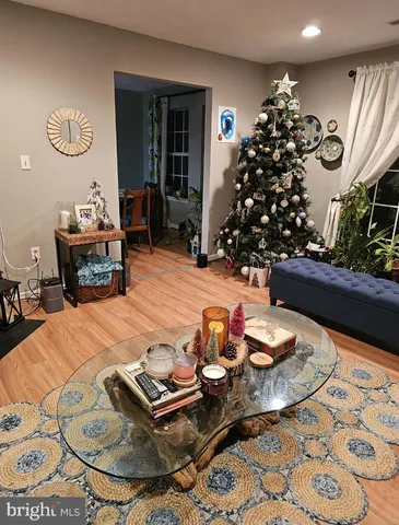 a living room with furniture and flowers