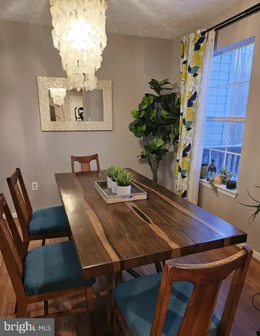 a view of a dining room with furniture and chandelier