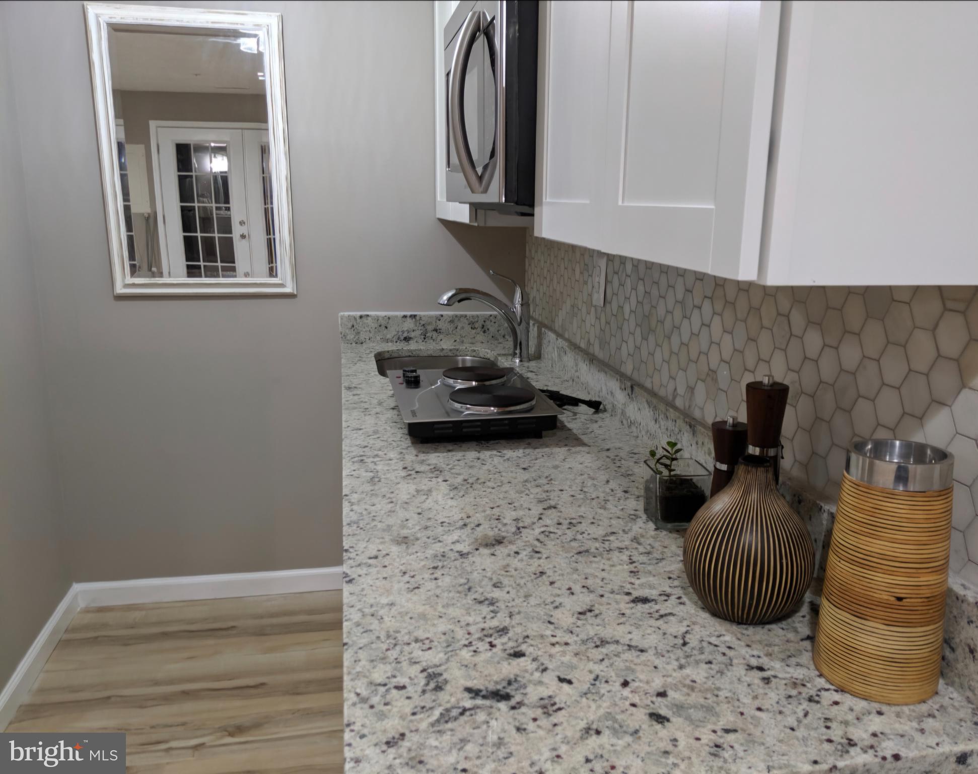 4657 Deepwood Court, Unit 106A Bowie, MD 20720 - Photo 19 of 29 a kitchen with a sink and a stove
