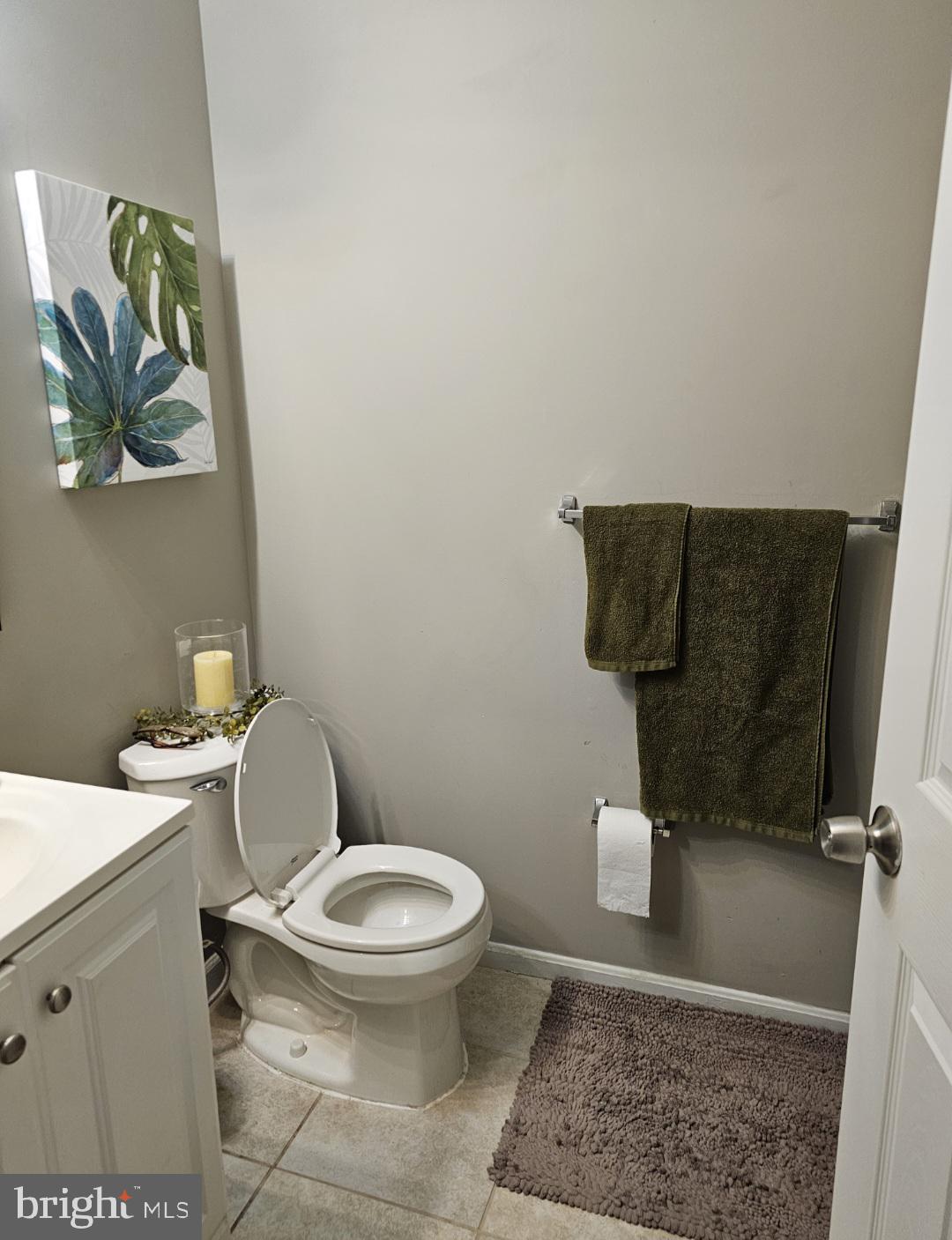 4657 Deepwood Court, Unit 106A Bowie, MD 20720 - Photo 6 of 29 a white toilet sitting next to a bathroom sink