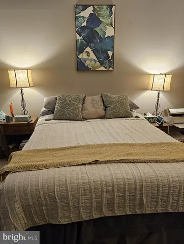 a bed sitting in a bedroom next to a lamp