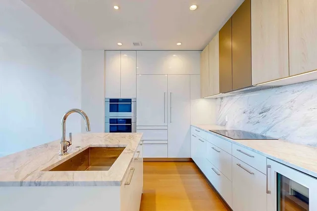 a kitchen that has a sink and a stove