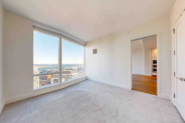 an empty room with large windows