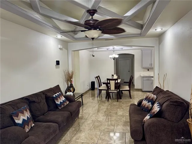 a living room with furniture and a chandelier