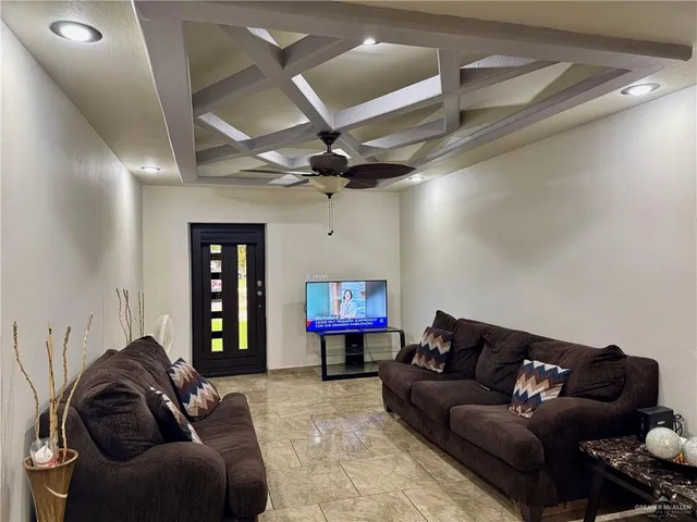 a living room with furniture a ceiling fan and a rug