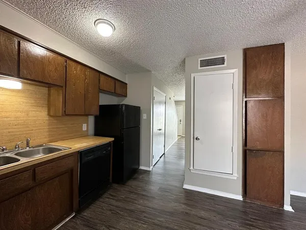 a kitchen with a refrigerator and a sink