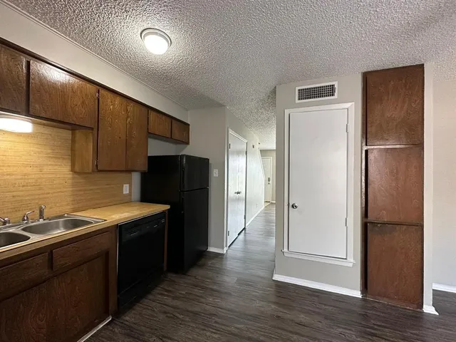 a kitchen with a refrigerator and a sink