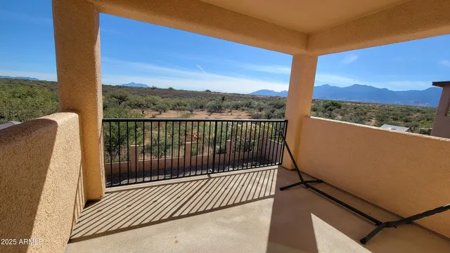 a view of a balcony with a floor to ceiling window and wooden fence