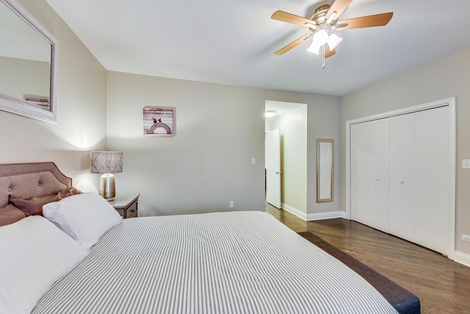 1532 West Fry Street, Unit 1 Chicago, IL 60642 - Photo 12 of 34 a bedroom with a large bed and a chandelier
