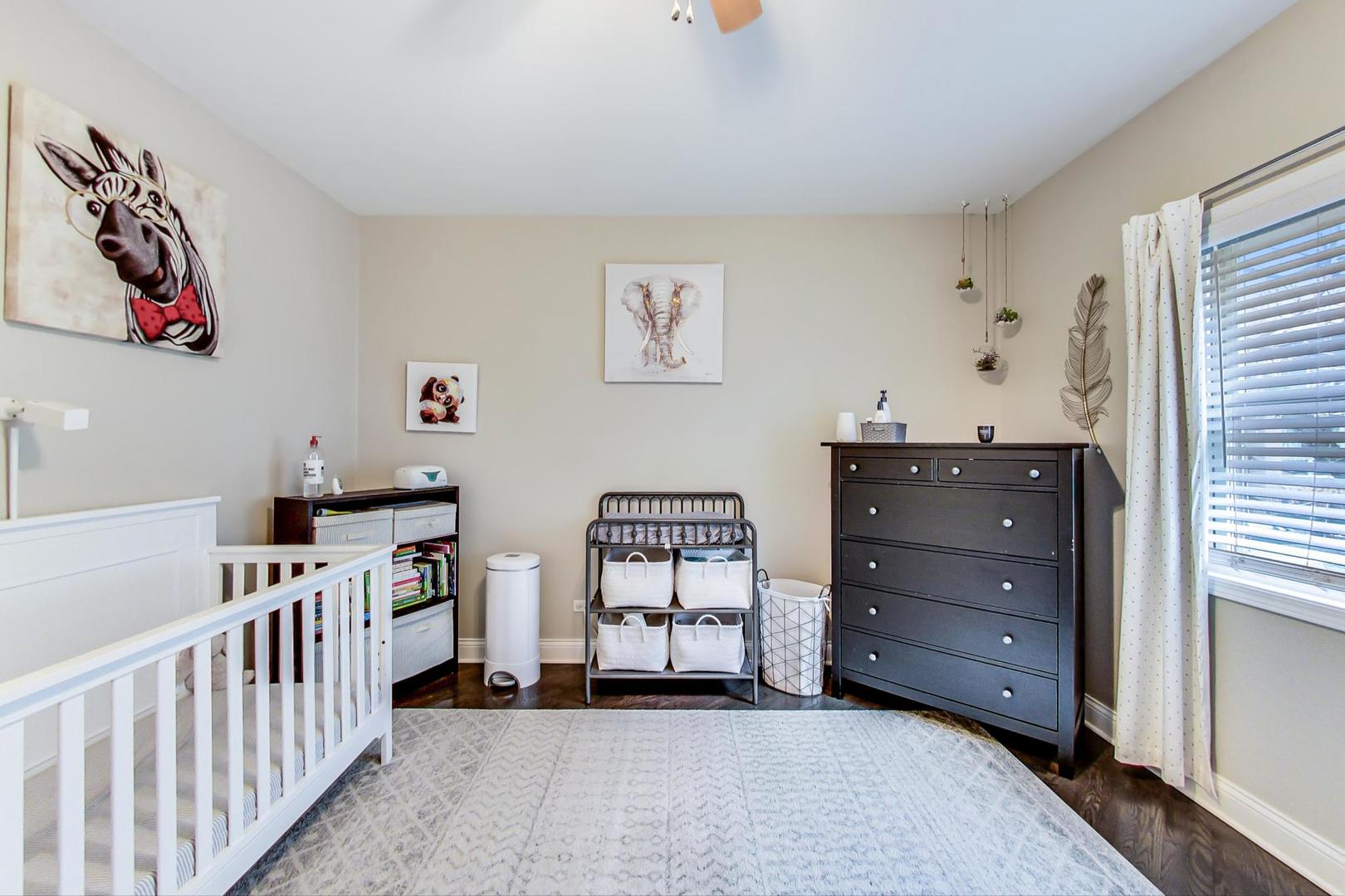 1532 West Fry Street, Unit 1 Chicago, IL 60642 - Photo 15 of 34 a view of a bedroom with baby crib and lounge chair
