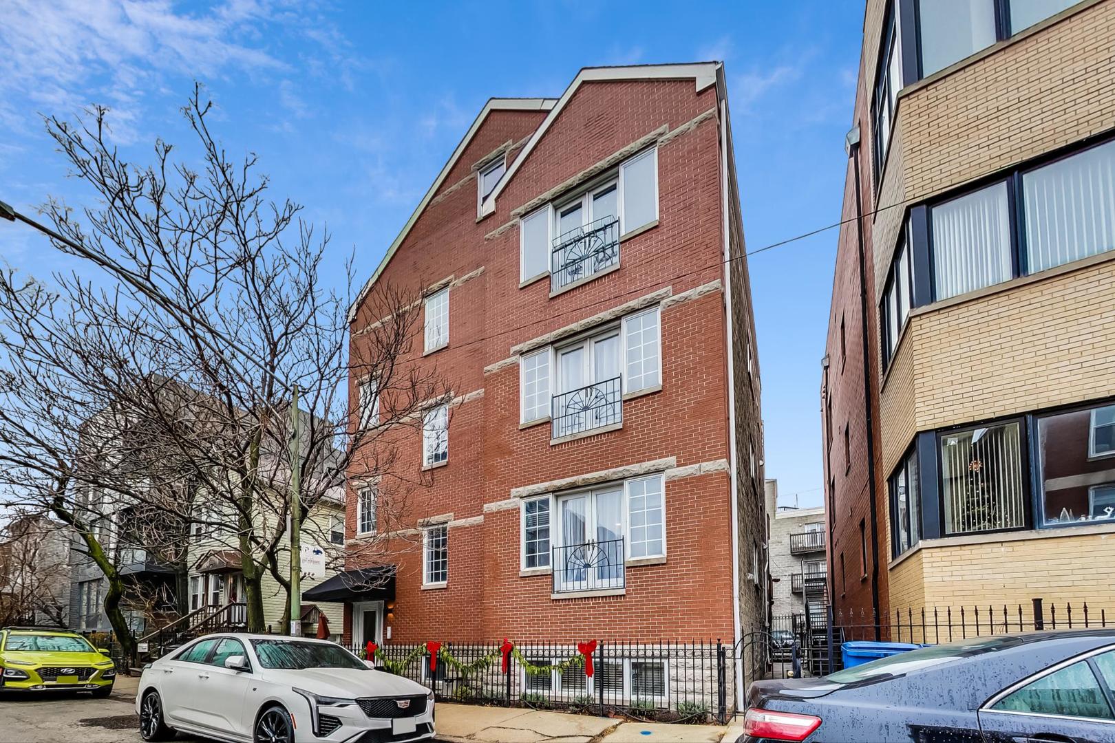 1532 West Fry Street, Unit 1 Chicago, IL 60642 - Photo 2 of 34 a front view of a building with lot of cars and trees
