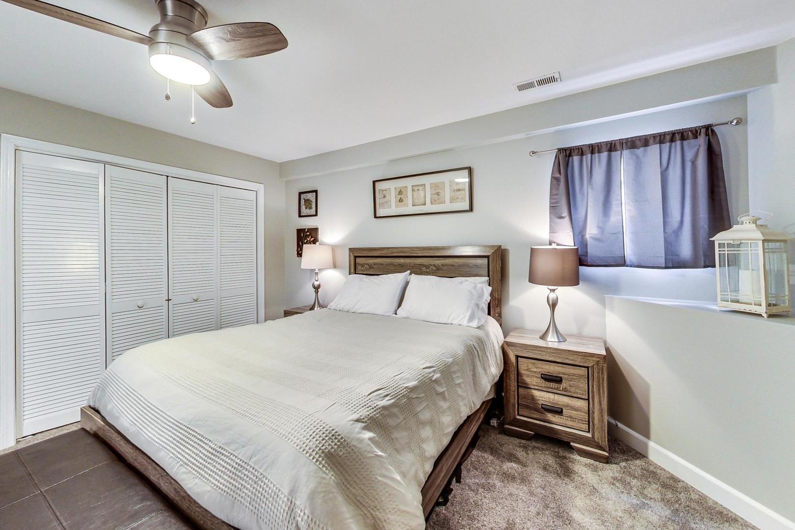 1532 West Fry Street, Unit 1 Chicago, IL 60642 - Photo 22 of 34 a bedroom with a bed and a chandelier