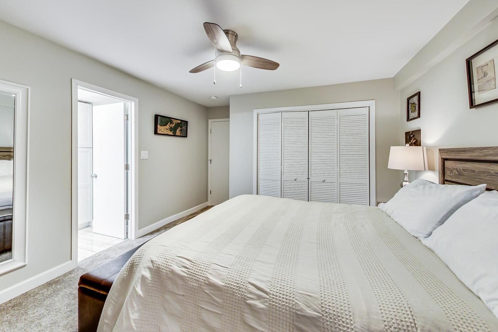 1532 West Fry Street, Unit 1 Chicago, IL 60642 - Photo 23 of 34 a bedroom with a large bed and a chandelier
