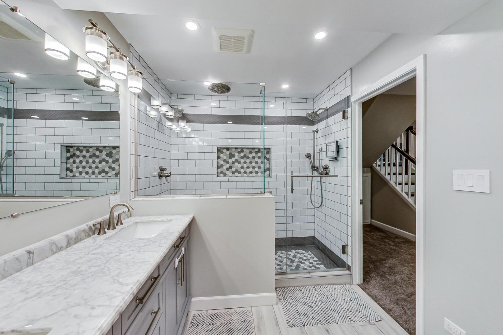 1532 West Fry Street, Unit 1 Chicago, IL 60642 - Photo 26 of 34 a bathroom with a granite countertop sink a mirror and shower
