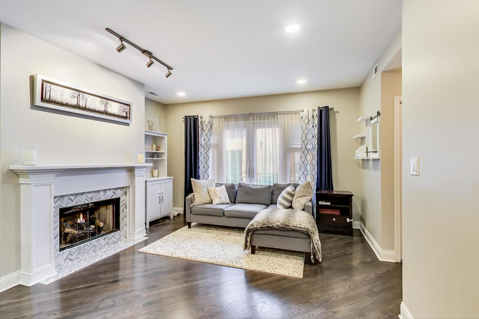 1532 West Fry Street, Unit 1 Chicago, IL 60642 - Photo 4 of 34 a living room with furniture and a fireplace