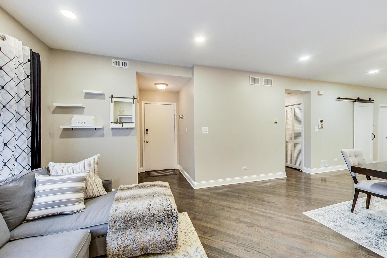 1532 West Fry Street, Unit 1 Chicago, IL 60642 - Photo 6 of 34 a spacious bedroom with a bed and furniture