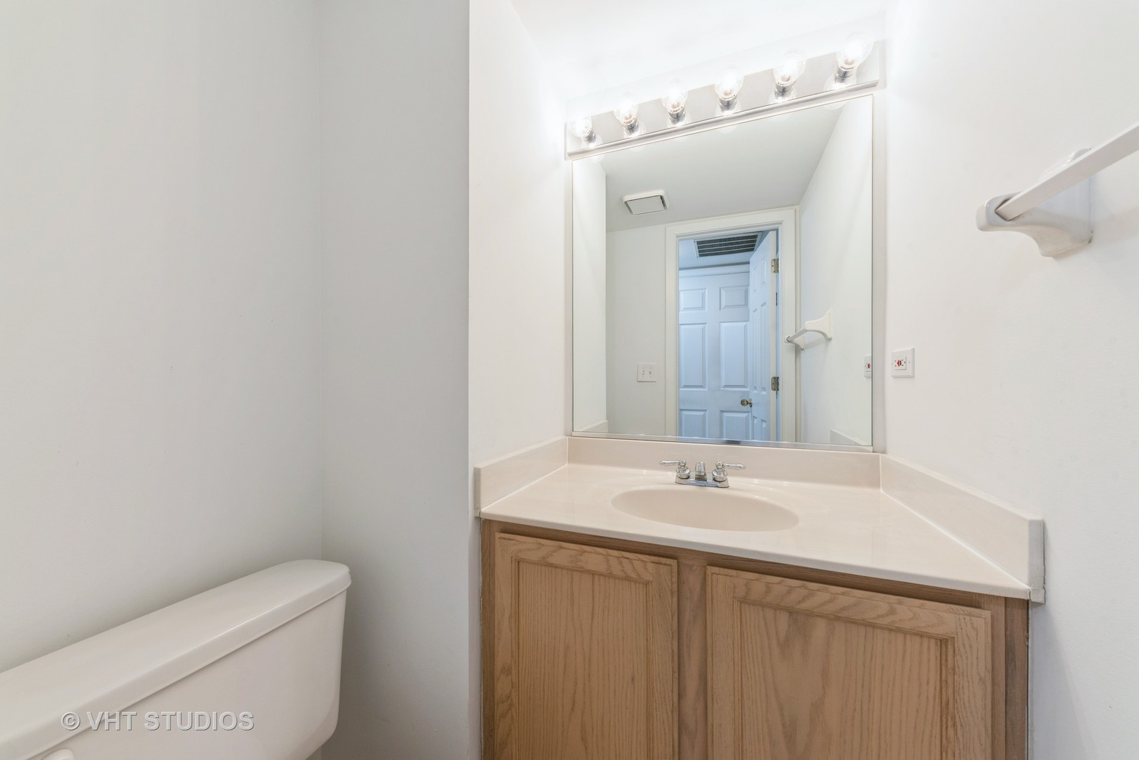 253 Hawk Court Schaumburg, IL 60193 - Photo 13 of 15 a bathroom with a sink a toilet and mirror