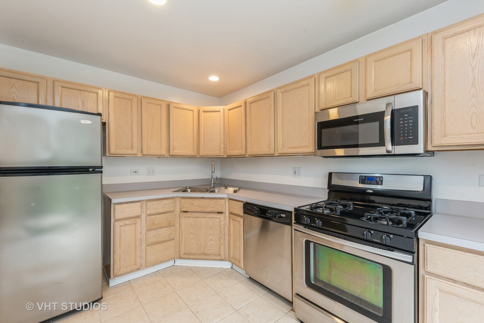 253 Hawk Court Schaumburg, IL 60193 - Photo 5 of 15 a kitchen with granite countertop cabinets stainless steel appliances and a sink