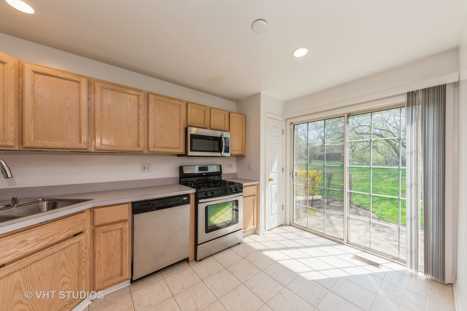 253 Hawk Court Schaumburg, IL 60193 - Photo 6 of 15 a kitchen with stainless steel appliances granite countertop a stove a sink and white cabinets