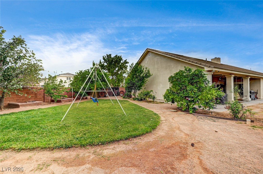 1140 Mahoney Avenue Logandale, NV 89021 - Photo 42 of 51 Rear view of property with a playground, stucco siding, and a patio