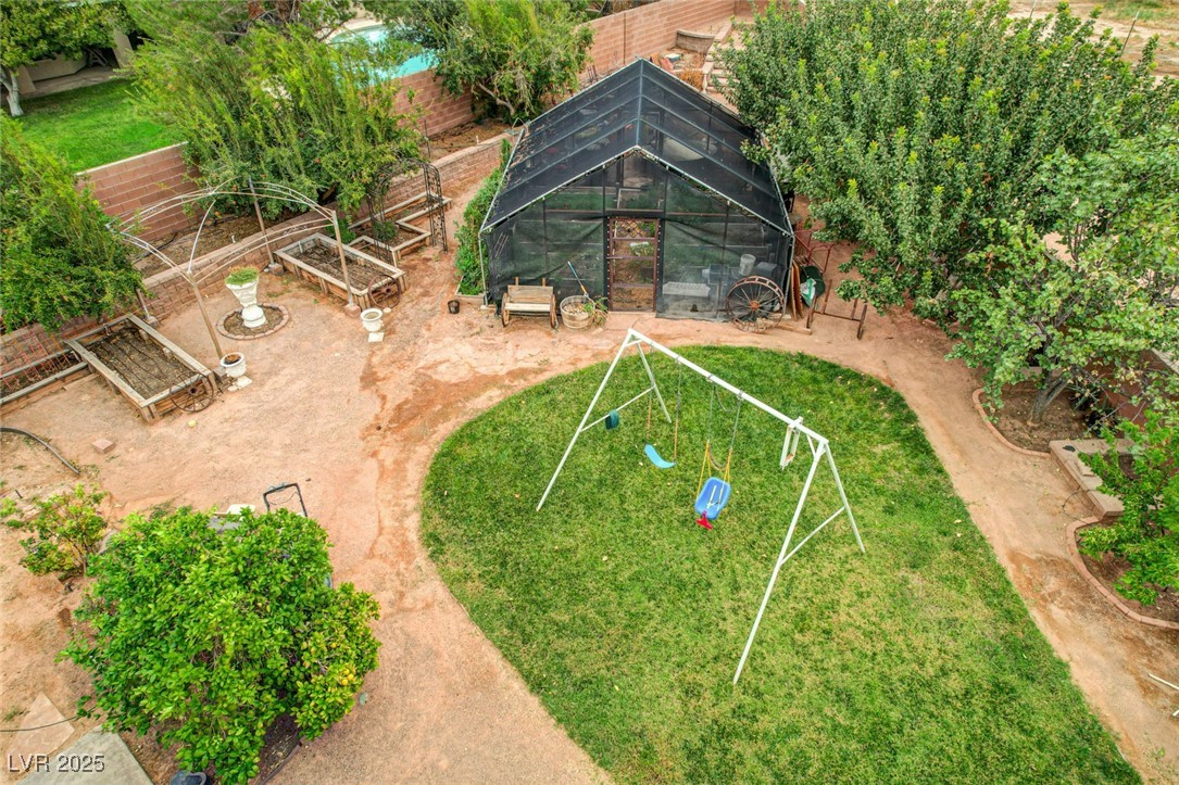 1140 Mahoney Avenue Logandale, NV 89021 - Photo 44 of 51 View of home's community with a garden, a sunroom, a playground, and a fenced backyard