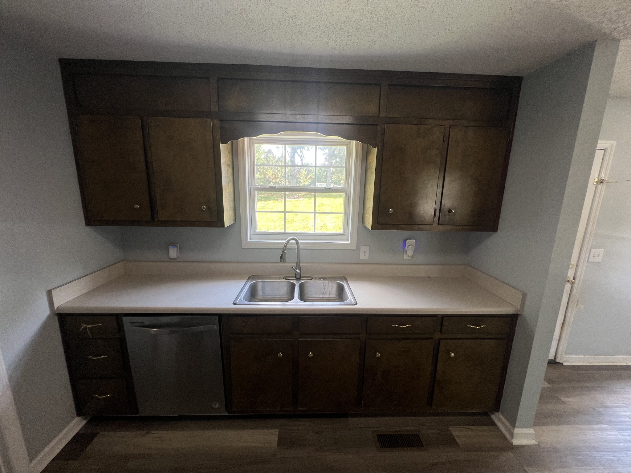 149 Hawthorne Street Pulaski, TN 38478 - Photo 10 of 33 a kitchen with a sink a window and cabinets