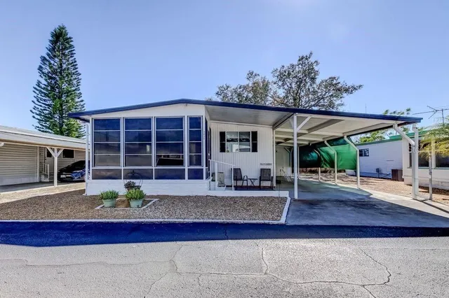 a front view of a house with garden and porch