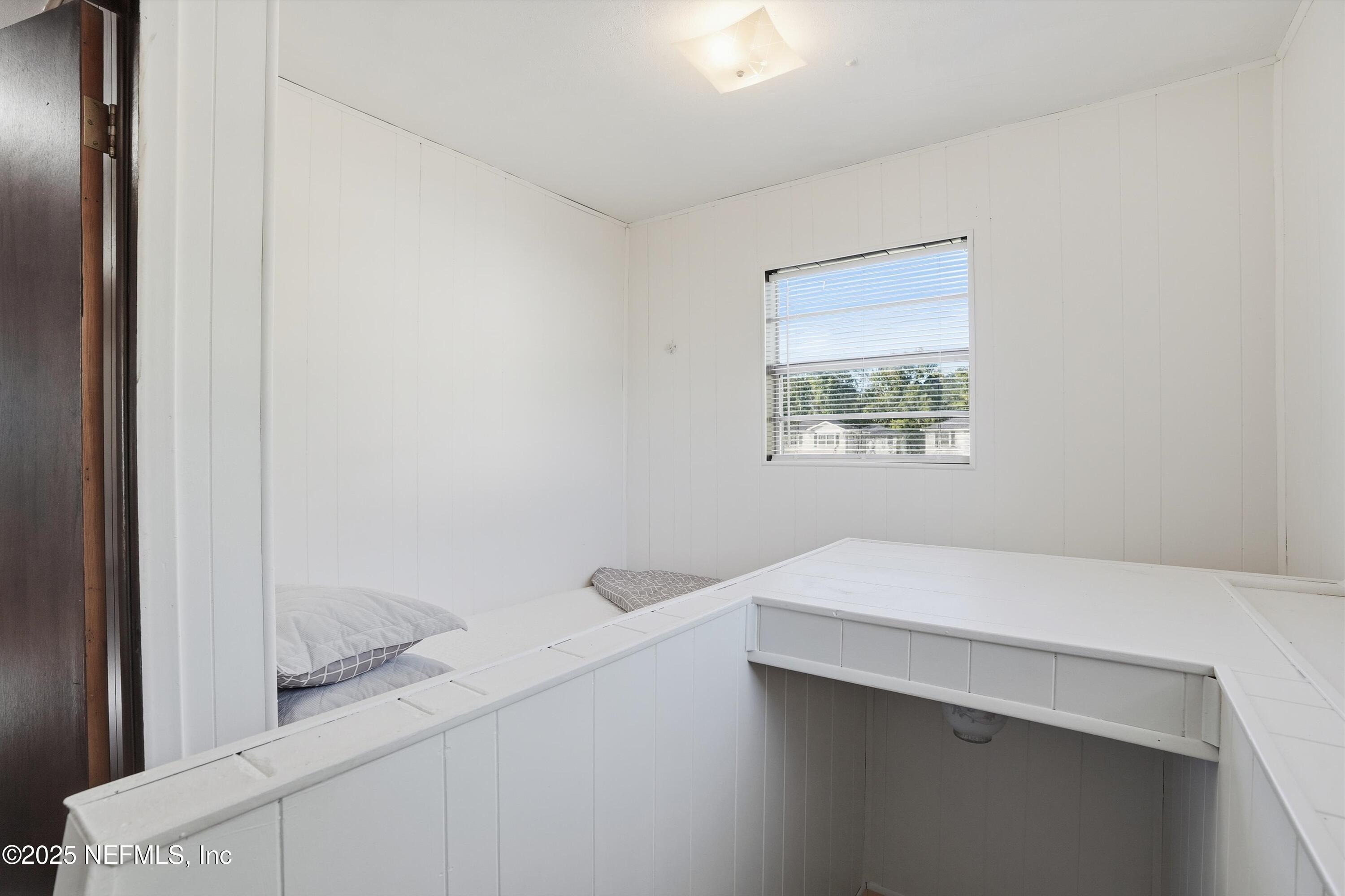 11558 Raft Road Jacksonville, FL 32218 - Photo 21 of 32 a bedroom with a bed and a window