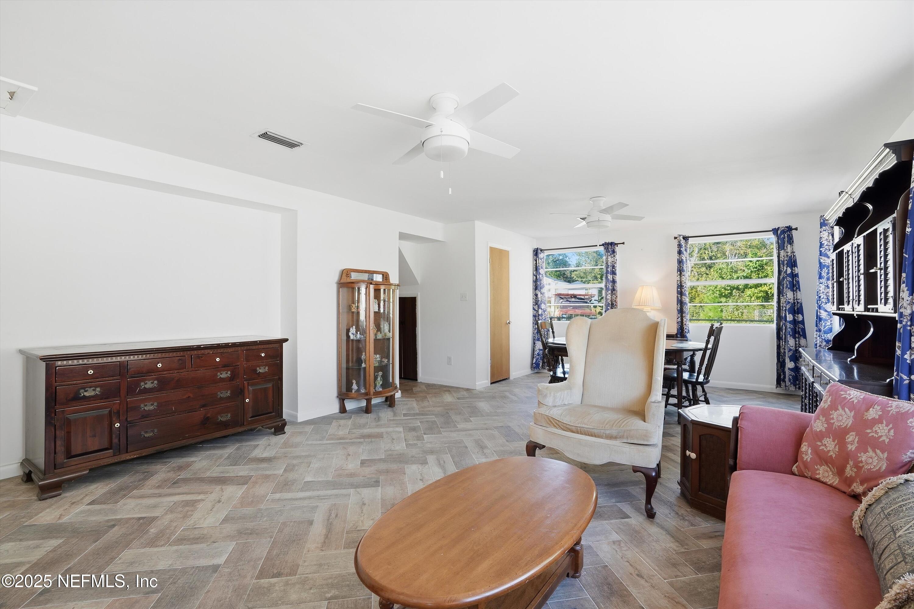 11558 Raft Road Jacksonville, FL 32218 - Photo 5 of 32 a living room with furniture and a dresser