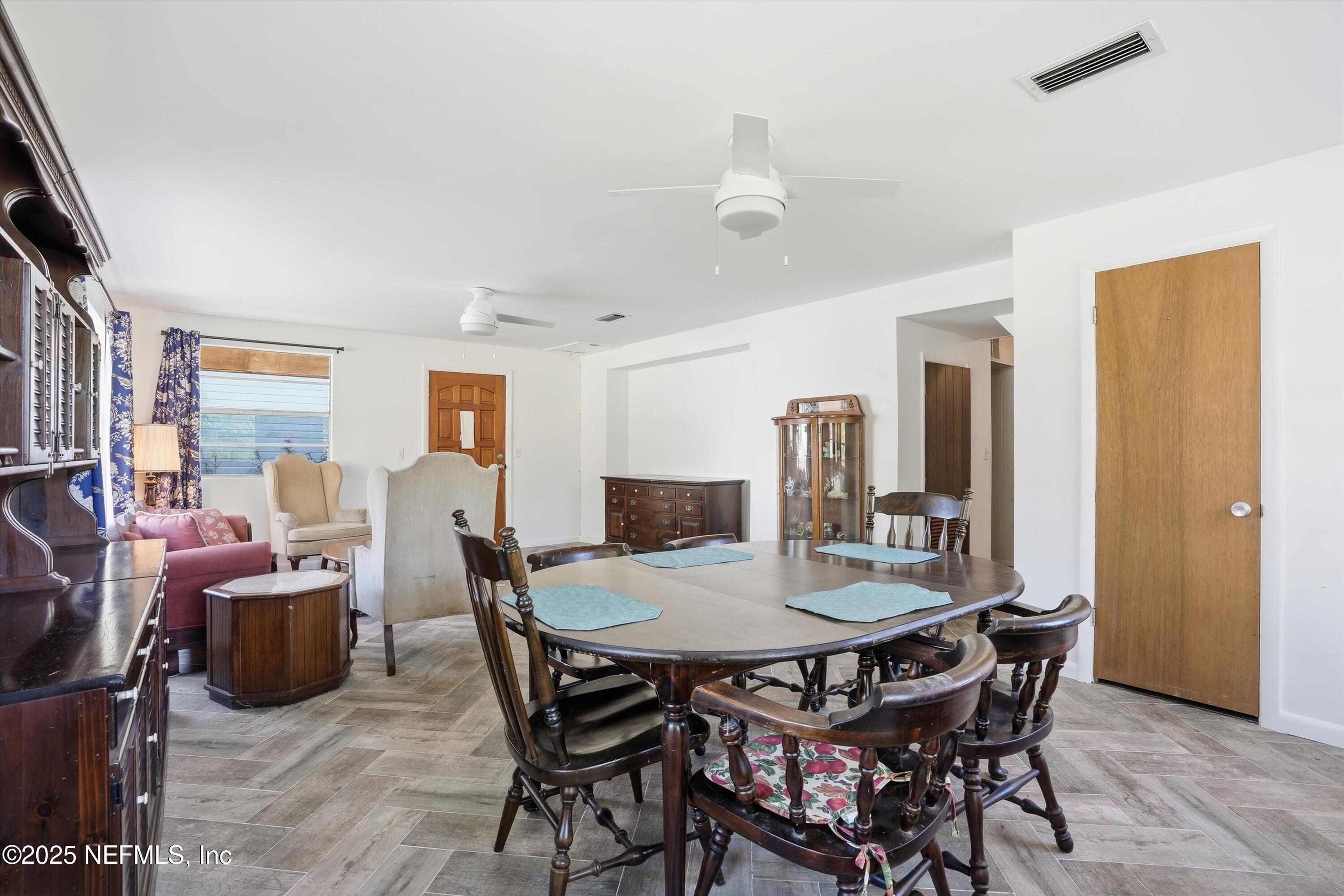 11558 Raft Road Jacksonville, FL 32218 - Photo 7 of 32 a view of a dining room with furniture and wooden floor