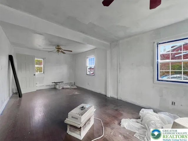 a view of a room with window and wooden floor