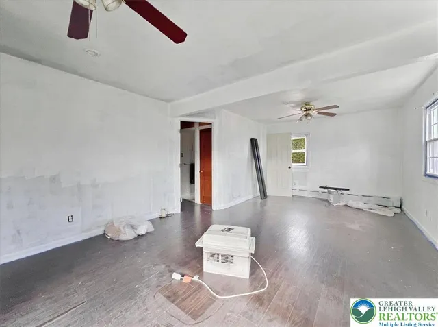 a view of a room with window and hardwood floor