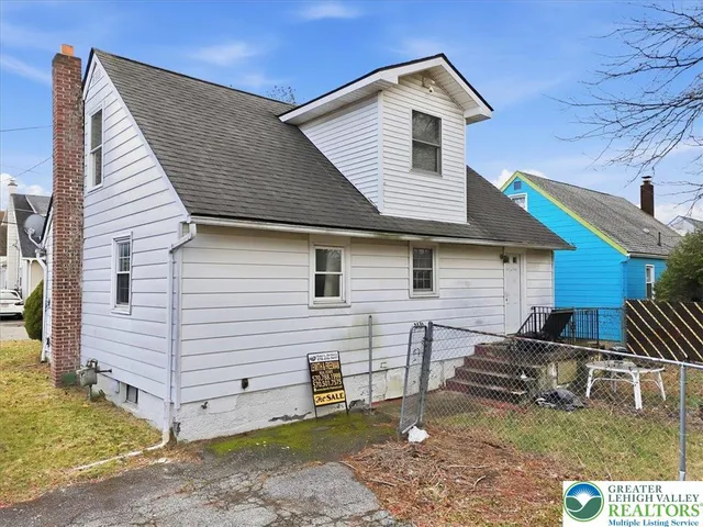 a balcony with table and chairs