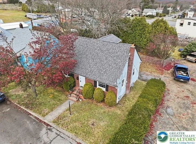 an aerial view of a house with outdoor space